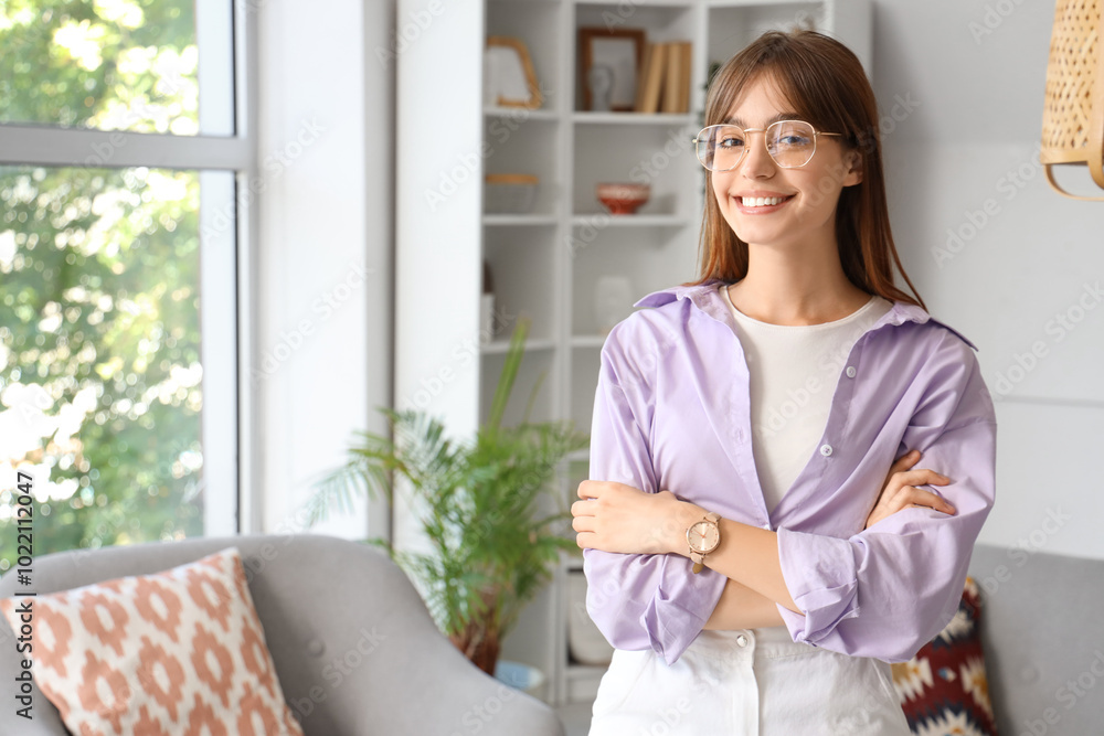 Wall mural Young woman in eyeglasses at home