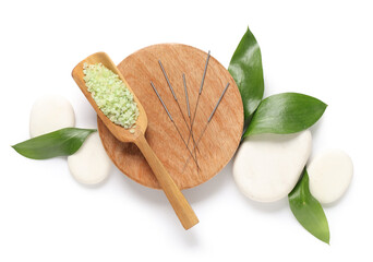 Acupuncture needles, sea salt and spa stones on white background