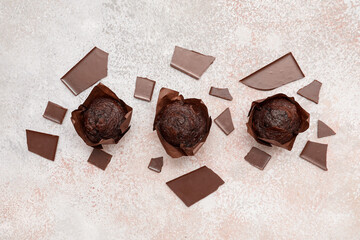 Tasty chocolate muffins on white grunge background