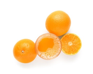 Glass of tasty juice with fresh oranges on white background