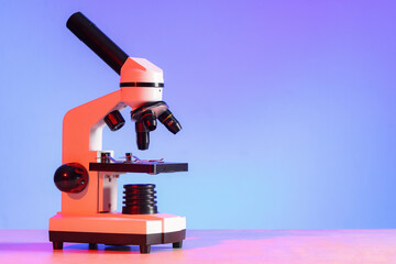 Modern microscope on white table