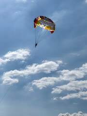 Parasailing in a clear blue sky with clouds. High quality photos