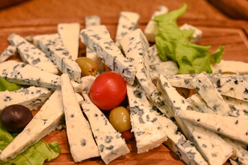 Blue cheese. Sliced ​​fresh cheese in a restaurant.