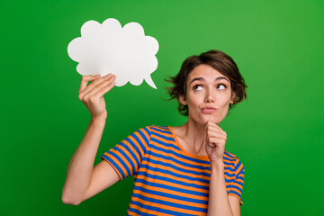 Photo of minded creative person arm touch chin look empty space cloud shape card isolated on green...