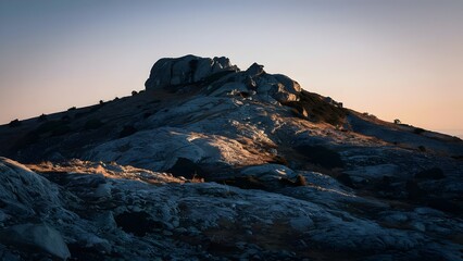 Obraz premium Rocky Hill at Sunrise with Warm Light