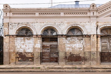 An abandoned and decrepit building on a small town main street.