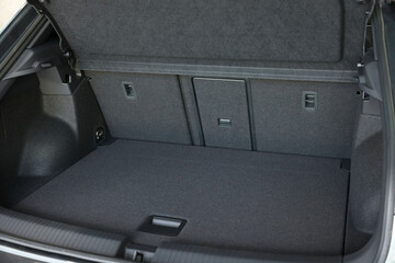 Grey soft car boot liner mat in trunk of auto