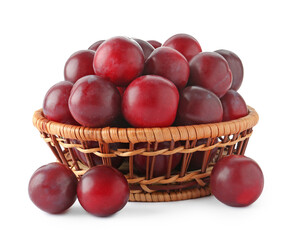 Fresh ripe plums in wicker bowl isolated on white