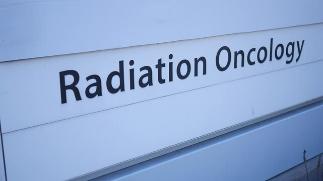 A sign reading radiation oncology near a hospital