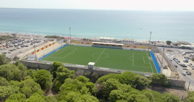 Aerial view of the Antonio Bianco municipal stadium, formerly the Lido San Giovanni stadium. It is a sports facility located near the sea and beaches in Gallipoli, in Salento, Puglia, Italy.