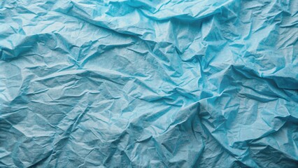 Obraz premium Softly rumpled blue paper texture with subtle wrinkles and gentle folds, resembling crumpled fabric, creating a calming and serene visual background.