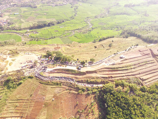 Aerial view of terraced dry hills in Bandung, Indonesia. Urban skyline in rural areas of Southeast Asia. Bandung City. Aerial Photography Concept