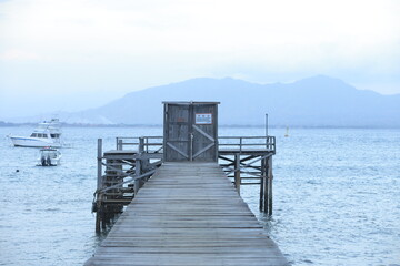 Wooden pier leading to the horizon over open waters.