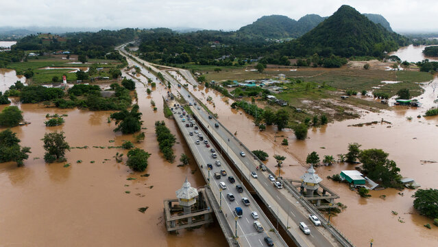 Aerial view of car driving on the bridge after road flooded during typhoon Yagi has swept Chiang Rai province of Thailand.