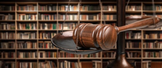 Justice scales in low library room