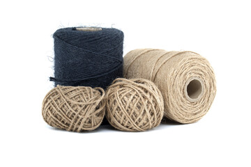 Collection of jute and twine spools on a white background, highlighting natural fiber materials