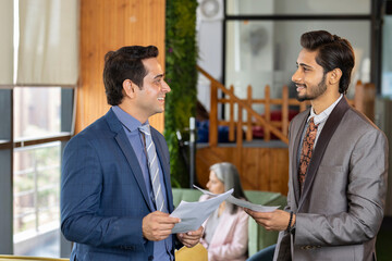 Two businesspeople having a discussion in an office