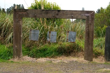 Three Iron Buckets Hanging from a Wooden Beam - Rustic and Vintage Display