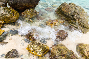 Serene Shoreline: Rocks and Waves at Tropical Beach