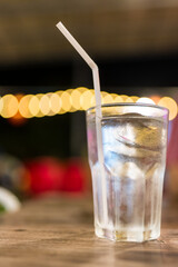 A glass of water with ice on a wooden table, clean water, drinking water