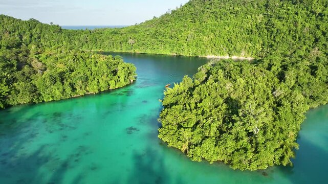 INDONESIA - 9.4.2024 - Very good aerial footage of a boat sailing along Teluk Lolong in Banggai, Indonesia.