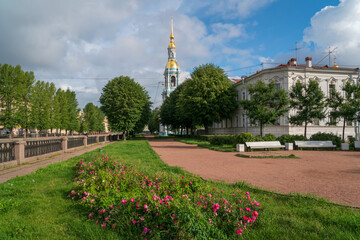 Obraz premium View of the Kryukov Canal embankment and the bell tower of St. Nicholas Naval Cathedral on a sunny summer day, St. Petersburg, Russia