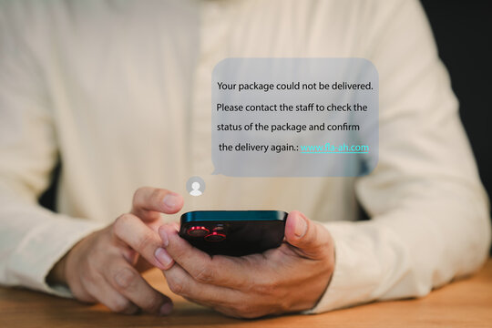 Person holds a smartphone displaying a notification about a failed package delivery. This message user to contact support and confirm delivery. Fake Text message SMS scam or phishing concept.