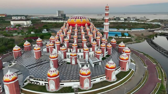 INDONESIA - 9.4.2024 - Great aerial footage moving up into an overhead view of the 99 Domes Mosque in Makassar, Indonesia.