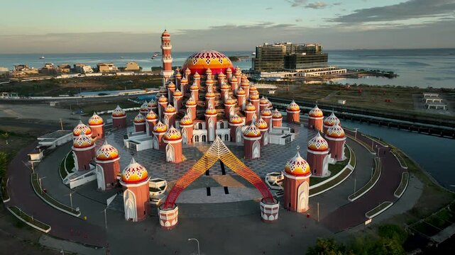 INDONESIA - 9.4.2024 - Fantastic aerial footage circling the 99 Domes Mosque in Makassar, Indonesia at sunset.