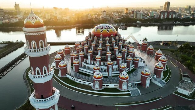 INDONESIA - 9.4.2024 - Incredible aerial footage circling the 99 Domes Mosque in Makassar, Indonesia on the water.