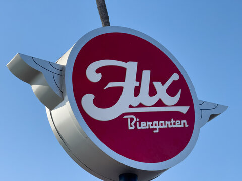 Retro Style Sign for Flx Biergarten Against Clear Blue Sky

