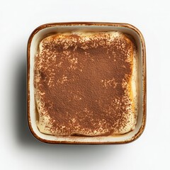 A topdown view of a classic tiramisu in a ceramic baking dish Light brown cocoa dusting on top contrasts with the creamy layers below Isolated on a white background, room for text