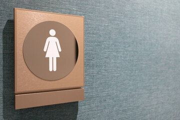 Female toilet sign on fabric wall. Copy space. Toilet sign on the wall in the shopping mall,...