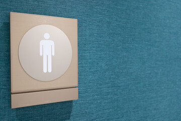 Male toilet sign on fabric wall. Copy space. Toilet sign on the wall in the shopping mall,...