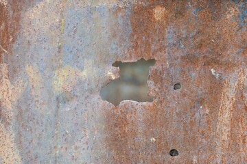 Hole in Rusty Metal Surface - Aged and Weathered Industrial Texture