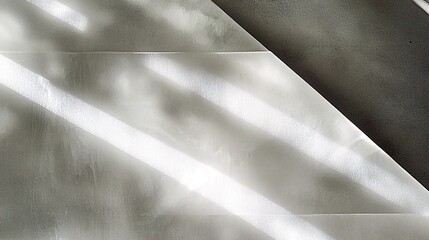 Obraz premium Abstract light and shadow pattern on a white wall.