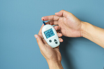 hand of people check diabetes and high blood glucose monitor with digital pressure gauge. Healthcare and Medical concept	