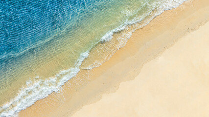 Top view beach sand background for summer vacation concept. Beach nature and summer seawater with sunlight light sandy beach Sparkling sea water	
