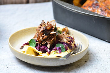 roasted duck meat, blue cabbage and potato pancakes, traditional Czech food, background of served food