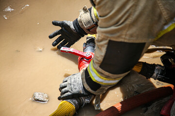 Firefighters extinguish a fire at a warehouse.