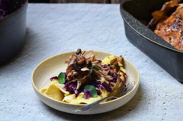 roasted duck meat, blue cabbage and potato pancakes, traditional Czech food, background of served food