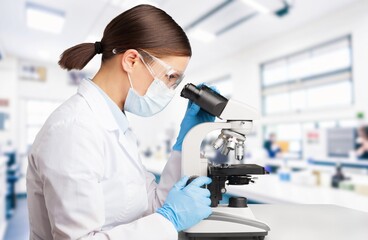 Biochemical research scientist conducting research in laboratory