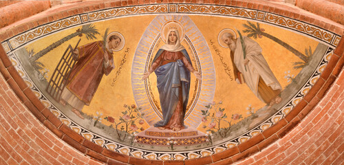PAVIA, ITALY - SEPTEMBER 9, 2024: The fresco of Virgin Mary among the St. Bartholomew and Lawrence...