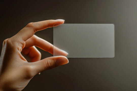A mockup of a hand holding a wide blank translucent card with the card is semi-transparent, serves as a clear call-card template
