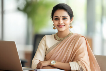 Indian woman in saree, seating confidently her desk at office