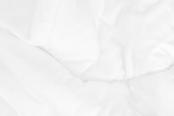 Obraz premium Close up top view of white bedding sheet and wrinkle messy blanket in bedroom after wake up in the morning.