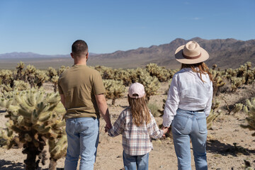 Family in Joshua tree National Park, Cholla cactus garden. USA, California