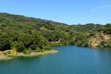Scenic view of calm water surface of Stevens Creek Reservoir at full capacity in Santa Clara County