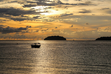 A beautiful sunset with small boat over the sea at Kota Kinabalu, Sabah, Malaysia
