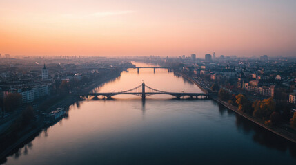 Obraz premium A bridge spanning across a wide river with a cityscape in the distance
